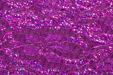 Abstract textured background of pink sequins and lace. 