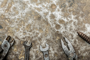 old worn tool on rumpled shabby metal, close-up abstract background