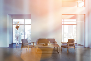 Woman in gray and white living room
