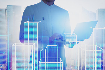 Man with laptop working with virtual city