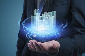 Businessman holding HUD city interface
