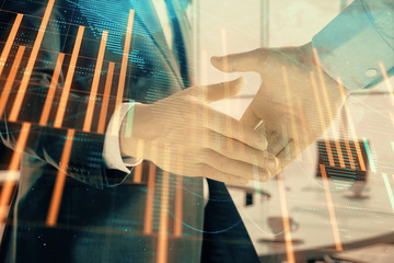 Multi exposure of financial chart and map on office background with two businessmen handshake. Concept of success in business