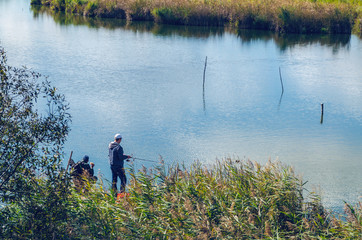 Fototapeta na wymiar A fisherman is fishing on the lake.