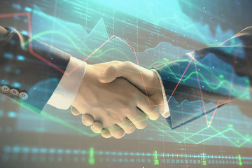 Multi exposure of forex graph on abstract background with two businessmen handshake. Concept of success on stock market