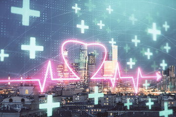 Multi exposure of human heart hologram on Moscow cityscape background. Concept of medical education