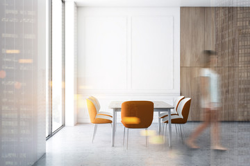 Woman walking in white and wooden dining room
