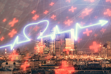 Multi exposure of human heart hologram on Moscow cityscape background. Concept of medical education