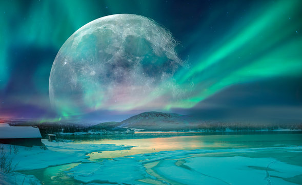 Northern lights (Aurora borealis) in the sky with super full moon - Tromso, Norway 