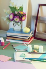 Books, flowers, apple, stationery, frames and colored paper on the table, education, back to school, summer, autumn