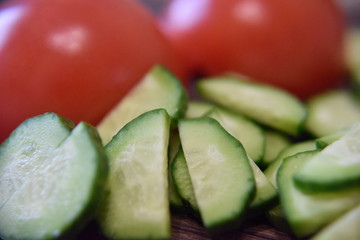 green  and red slices of cucumbers and tomato