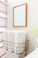 Modern Bathroom, Toilet with towels on top and blank picture frame