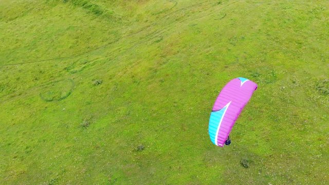 Top view of a person with the paraplane flying in the air. Paraglider flying.