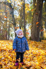 girl watching leaves falling down on her