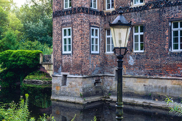 The illuminated medieval castle Vischering in the west of germany with a bit of foreground.