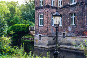 The illuminated medieval castle Vischering in the west of germany with a bit of foreground.