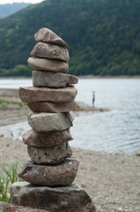 Fototapeta na wymiar Closeup of rocks balance in border lake