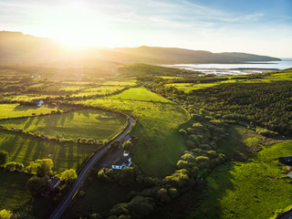 Aerial view of endless lush pastures and farmlands of Ireland. Beautiful Irish countryside with...