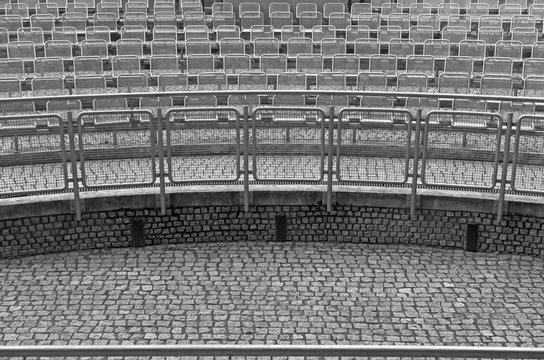 Front View From The Scene To Empty Theatre Seats. Empty Spectator Chairs Of Public Open Amphitheater In City Park, European Urban Style.