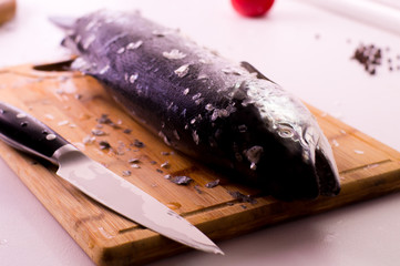 Raw fresh salmon on wooden cutting board
