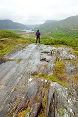 Hiker admiring the beauty of Killarney National Park at Lady's View viewpoint. One of most impressive overlooks on the Ring of Kerry, Ireland.