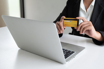 Business woman consumer holding credit card for online shopping and payment make a purchase on the Internet