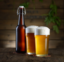 Beer. Beer bottle and glass on a wooden background