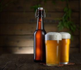 Beer. Beer bottle and glass on a wooden background