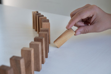 Hand pull block wood game, gambling placing wooden block. Concept Risk of management and strategy plan, protect business