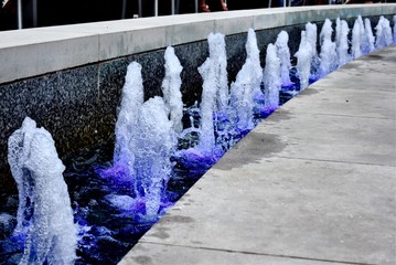 Fountain with a row of spouts - obrazy, fototapety, plakaty