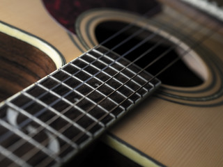 Obraz premium six - string acoustic guitar on a black background. low key. music day