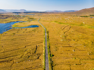 Beautiful sunset view of Connemara region in Ireland. Scenic Irish countryside landscape with magnificent mountains on the horizon, County Galway, Ireland.