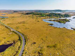 Beautiful sunset view of Connemara region in Ireland. Scenic Irish countryside landscape with magnificent mountains on the horizon, County Galway, Ireland.