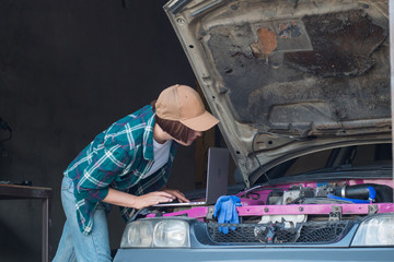Female mechanic fixing car  in a garage