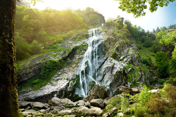 Majestic water cascade of Powerscourt Waterfall, the highest waterfall in Ireland. Tourist...