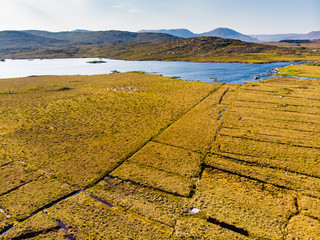 Beautiful sunset view of Connemara region in Ireland. Scenic Irish countryside landscape with magnificent mountains on the horizon, County Galway, Ireland.