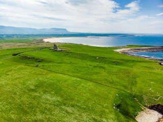 Fototapeta na wymiar Spectacular aerial view of Mullaghmore Head with huge waves rolling ashore. Picturesque scenery with magnificent Classiebawn Castle.