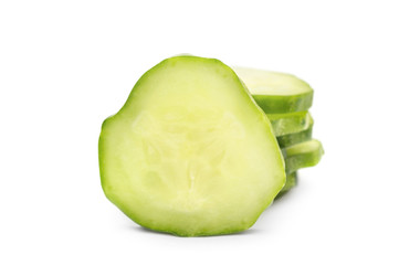 Stack of pieces of cutted cucumber on white.