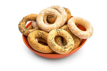 Plate with dried bagels on white.