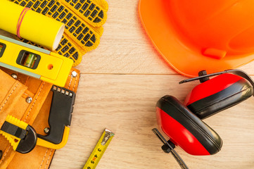 Protective equipment and tools in a bag for a builder.