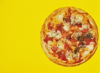 Delicious pizza on yellow background.