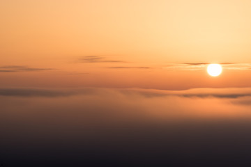 The sun is just above the clouds