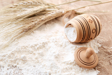 The concept of the grain industry and food. On the table, barrels of flour, sifted flour and wheat. Beautiful background for banners.