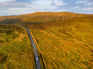 Sunset view of Connemara region in Ireland. Scenic Irish countryside landscape with magnificent mountains on the horizon, County Galway, Ireland.