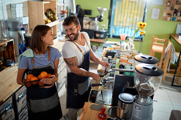 Couple barista working at coffee shop.