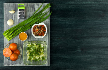 Zucchini in the background. Fried young sliced courgettes in a pan on a dark background. The view from the top. Copy space