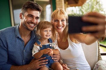 Family making selfie with daughter