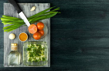 Zucchini in the background. Fried young sliced courgettes in a pan on a dark background. The view from the top. Copy space