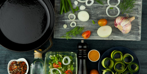 Zucchini in the background. Fried young sliced courgettes in a pan on a dark background. The view from the top. Copy space