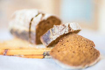 Sliced black bread on the old wooden board.