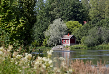A sauna cottage on the river bank on a sunny day 